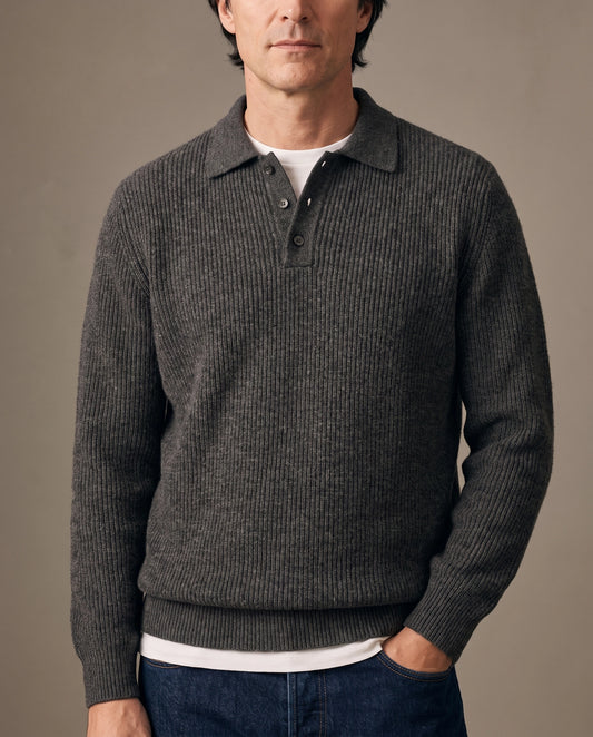 Model wearing a dark gray ribbed knit polo sweater