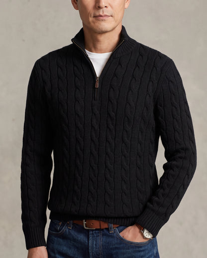 Model  wearing a black cable-knit quarter-zip sweater with a high mock neck