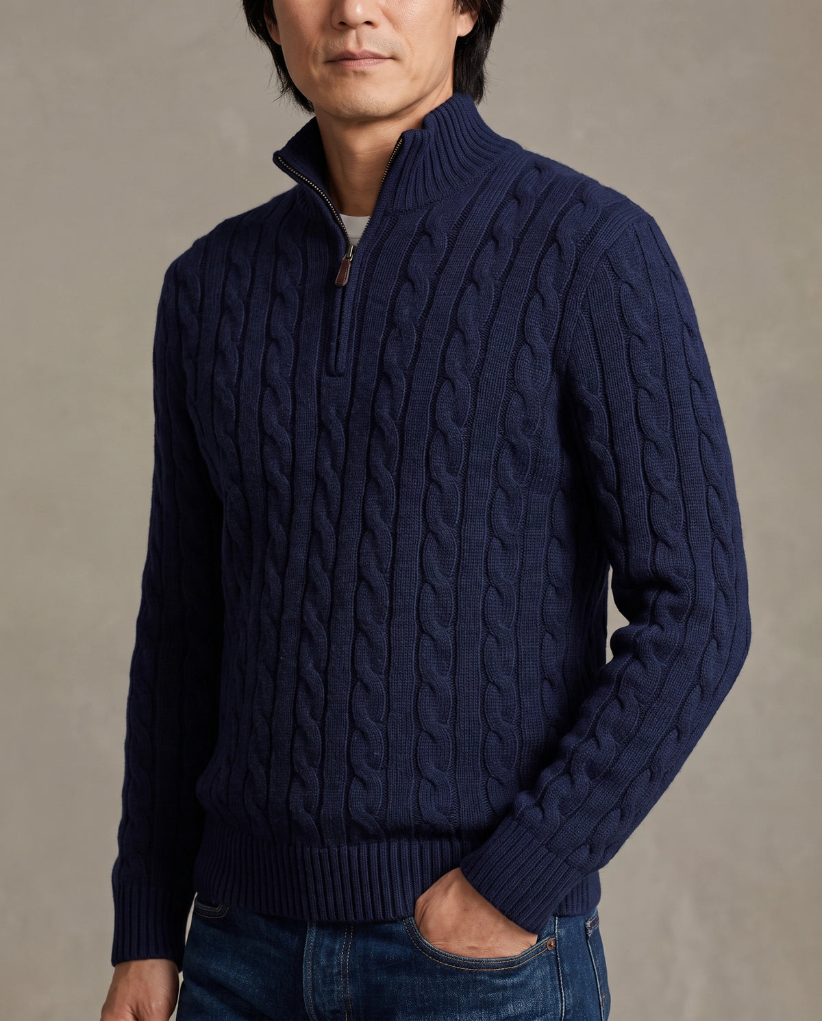 Model wearing a navy blue cable-knit quarter-zip sweater with a high mock neck