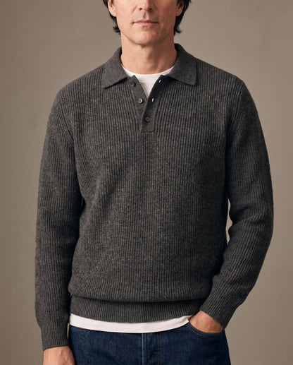 Model wearing a dark gray ribbed knit polo sweater
