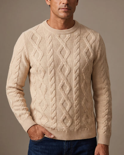 A man wearing a beige cable-knit crewneck sweater
