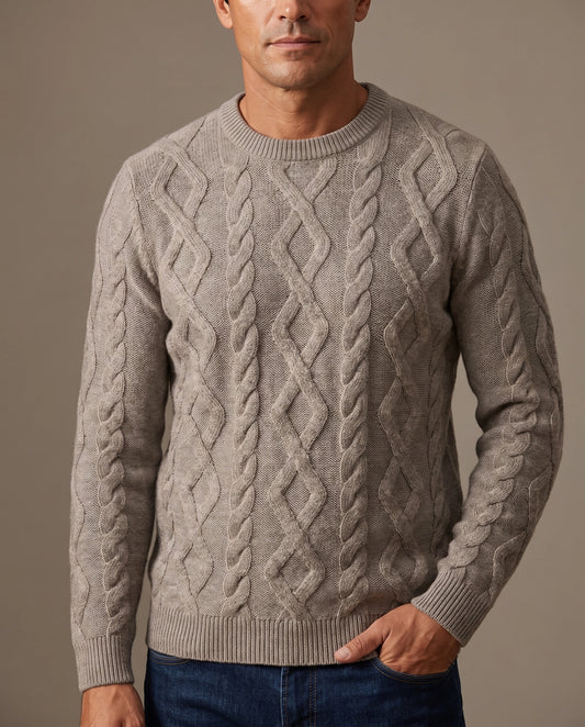 A man wearing a grey cable-knit crewneck sweater