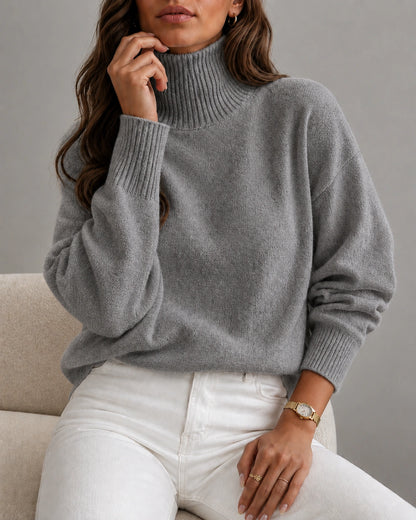 woman wearing a cozy grey ribbed turtleneck sweater
